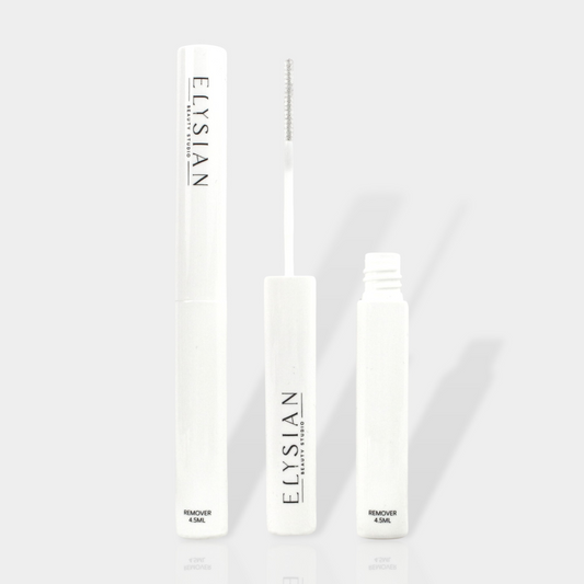 Romoval serum standing upright one closed bottle and next to it is what the brush looks like